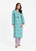 A woman modeling a turquoise and white printed kurta with matching patterned pants against a plain white studio background.