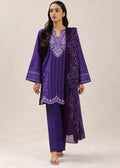 A woman modeling a purple traditional outfit consisting of a long-sleeved embroidered kurta, matching trousers, and a sheer embroidered dupatta, set against a plain beige studio background.