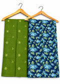 Two folded fabric garments hanging on wooden hangers against a white background. The left garment is olive green with small yellow embroidered motifs, and the right garment is navy blue with a light blue and yellow floral print.