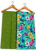 Two folded fabric pieces hanging on wooden hangers against a white background. The left piece is olive green with small yellow embroidered motifs, and the right piece has a bright turquoise floral print with pink, yellow, blue, and white flowers.