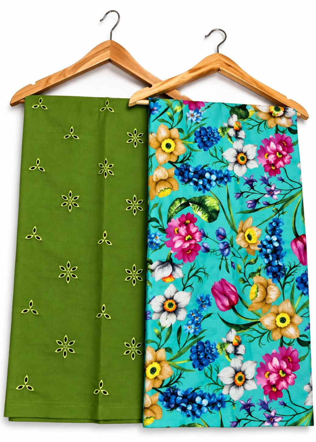 Two folded fabric pieces hanging on wooden hangers against a white background. The left piece is olive green with small yellow embroidered motifs, and the right piece has a bright turquoise floral print with pink, yellow, blue, and white flowers.