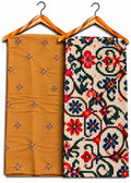 Two folded patterned textiles hanging on wooden hangers against a white background. The left textile is a warm mustard yellow with small embroidered floral motifs.