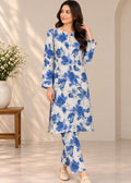 A woman models a white three-piece kurta set with a blue floral print, consisting of a long-sleeve tunic, matching pants, and a separate dupatta, in a brightly lit indoor setting.