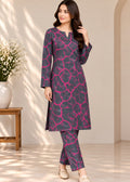 A woman models a three-piece Indian ethnic wear set featuring a dark gray kurta and trousers with a vibrant pink abstract web-like pattern, paired with beige flat shoes in a softly lit indoor setting.