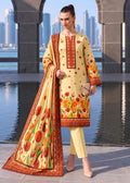 A woman models a three-piece traditional South Asian salwar kameez suit set. The set features a light yellow kurta with red and orange floral patterns and geometric borders, matching yellow trousers, and a coordinating dupatta with a large red tulip print and orange border.