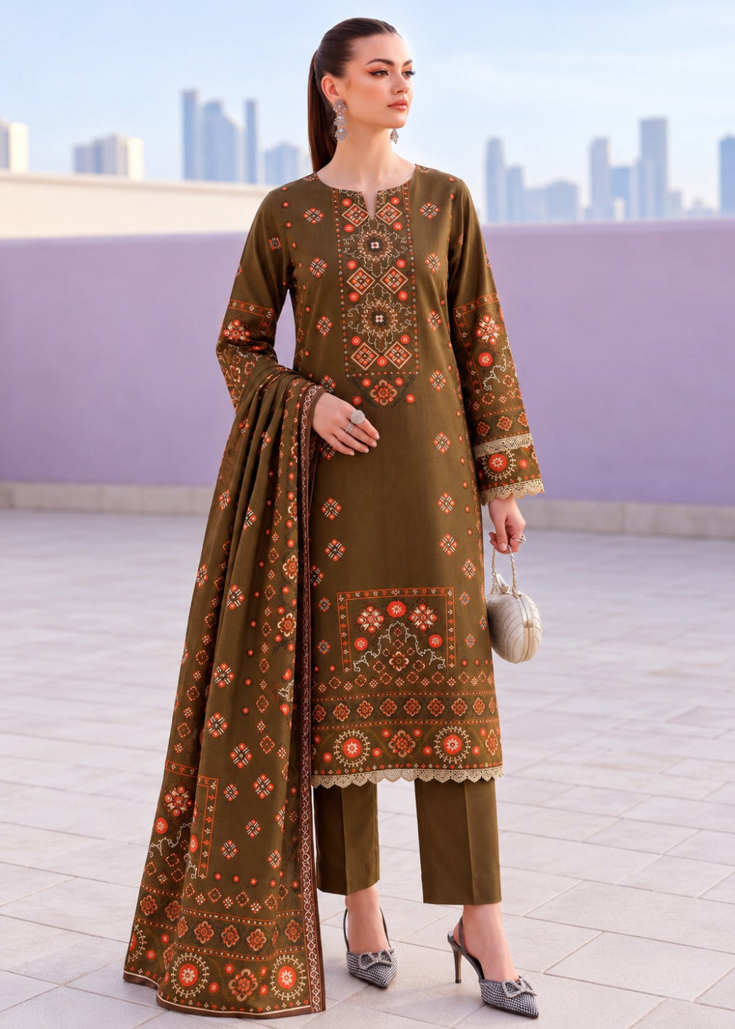 A woman modeling a brown ethnic kurta with intricate orange and beige geometric embroidery, paired with a matching dupatta, set against a blurred cityscape background.