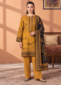 A woman models a traditional three-piece salwar kameez suit in mustard yellow and black. The kurta features black floral embroidery and border prints, paired with matching yellow trousers and a black dupatta with ornate gold borders and floral motifs.