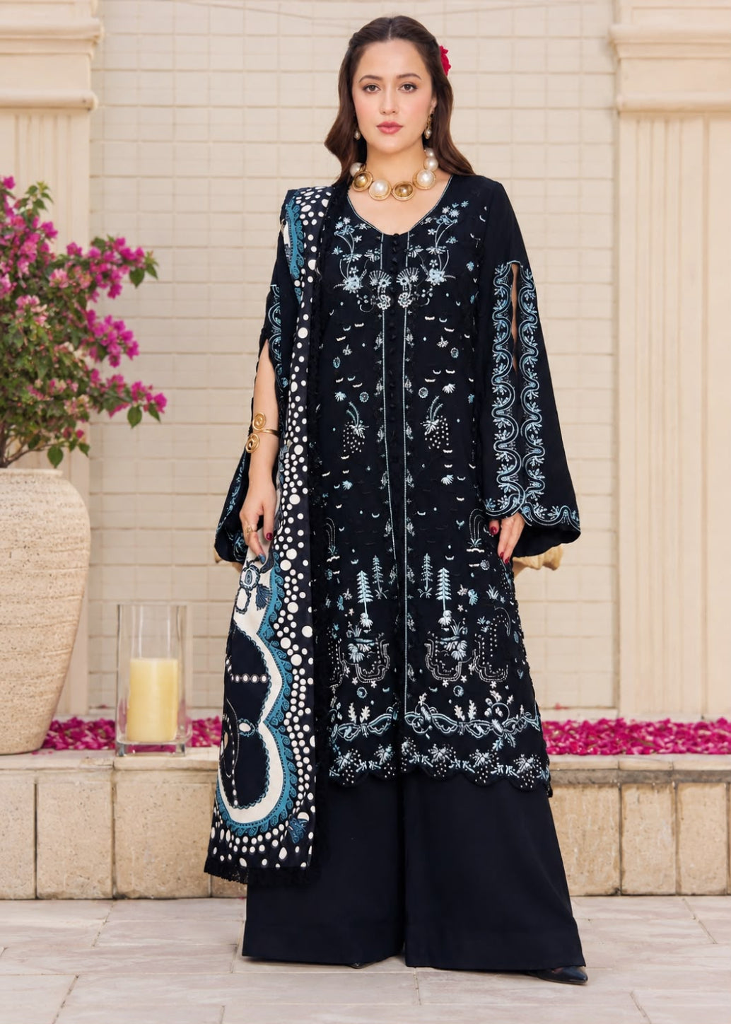 A woman models a traditional three-piece beige ethnic suit with brown floral embroidery and a matching dupatta, set against a beige wooden grid wall background.