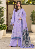 A woman models a traditional three-piece beige ethnic suit with brown floral embroidery and a matching dupatta, set against a beige wooden grid wall background.