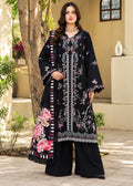 A woman models a traditional three-piece beige ethnic suit with brown floral embroidery and a matching dupatta, set against a beige wooden grid wall background.