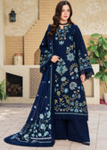 A woman models a traditional three-piece beige ethnic suit with brown floral embroidery and a matching dupatta, set against a beige wooden grid wall background.