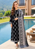 A woman stands by a swimming pool wearing a black and gray printed ethnic kurta set with a matching dupatta. The outfit features gray and white geometric and floral patterns on a black base.