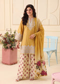 A woman models a traditional three-piece salwar kameez suit. The outfit consists of a mustard yellow embroidered tunic, wide-leg beige trousers with pink floral prints, and a matching yellow-to-beige gradient dupatta with floral embroidery and a butterfly print.