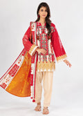 A woman modeling a traditional South Asian outfit featuring a red kurta with intricate gold and white embroidery, beige pants, and a bright orange dupatta with red and white patterns, set against a plain white studio background.