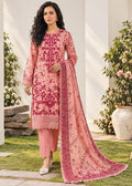 A woman models a traditional pink ethnic suit set featuring a heavily embroidered pink kurta, matching pink trousers, and a long pink dupatta with floral embroidery, set against an outdoor garden backdrop.