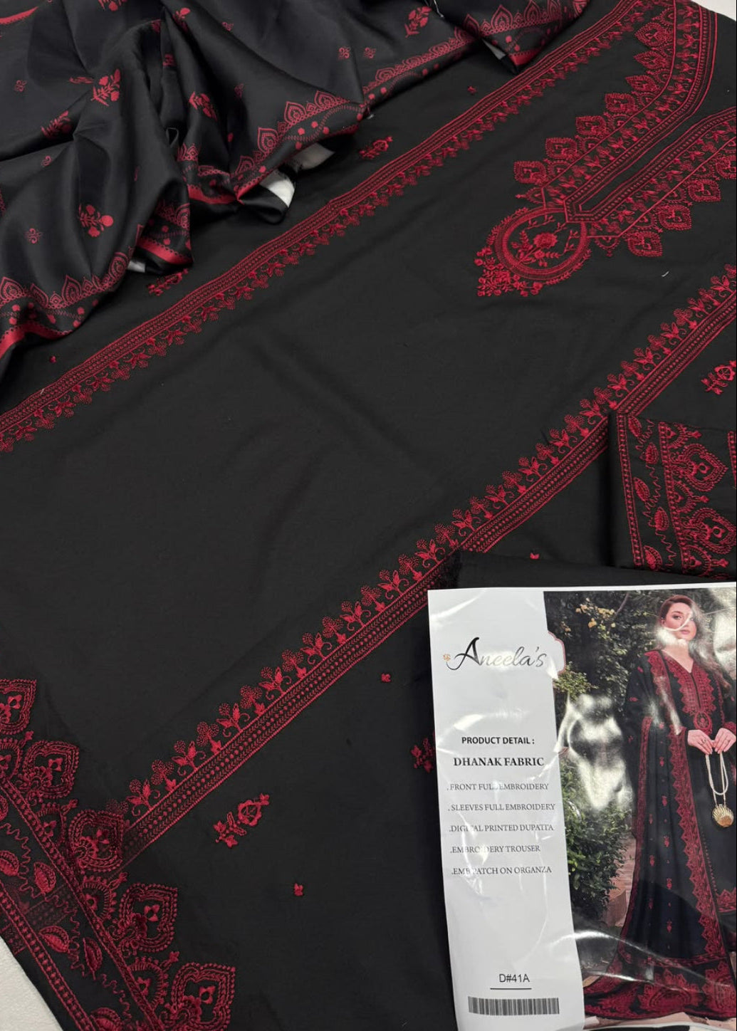 Black and red printed ethnic fabric with ornate border embroidery, shown with a product tag that reads 'Anusha's Dhnal's Fabric'.