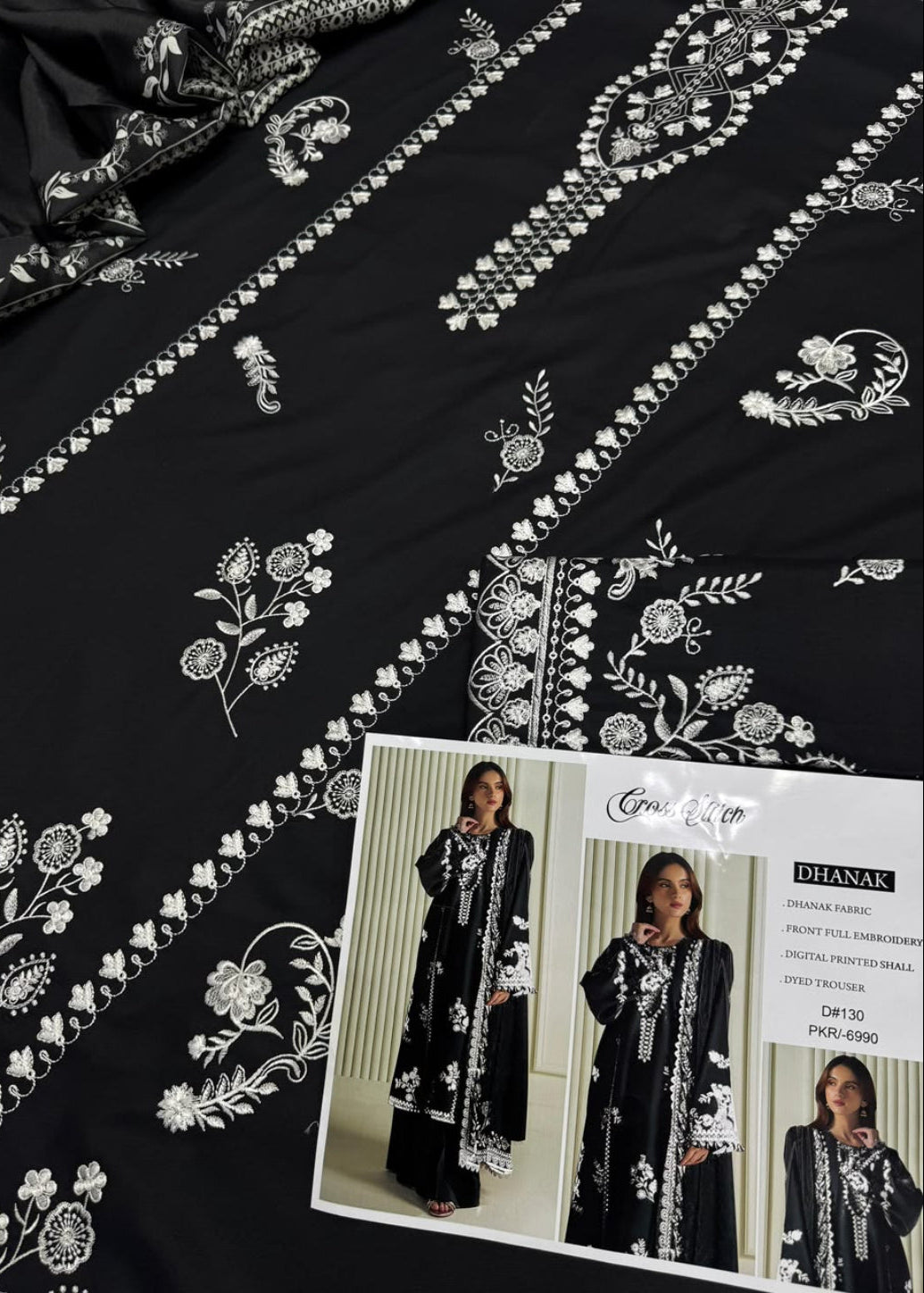 Black embroidered kurta fabric with white floral and geometric patterns, shown with a printed brand card featuring model photos. The brand name Bihanak is visible on the card.