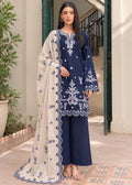 A woman models a navy blue three-piece ethnic suit with intricate white embroidery, featuring a long-sleeve kurta, matching wide-leg trousers, and a sheer cream dupatta with a navy blue border.