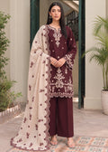 A woman models a three-piece traditional South Asian salwar kameez suit. The kurta is deep maroon with intricate cream and gold embroidery, paired with matching maroon wide-leg trousers and a cream dupatta featuring a scalloped maroon border and embroidered motifs.