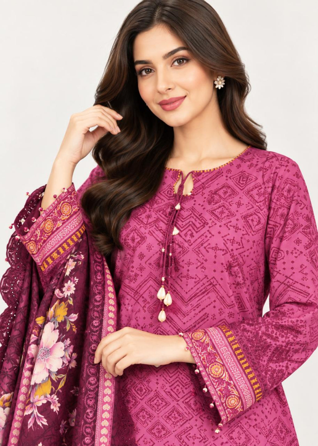 A woman modeling a magenta printed ethnic kurta with a matching floral dupatta, set against a plain light gray background.