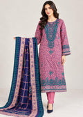 A woman models a traditional three-piece salwar kameez suit. The kurta is a dusty pink with teal and purple floral prints and heavy embroidery on the chest.