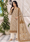 A woman models an elegant beige and gold ethnic suit set featuring a heavily embroidered kurta, matching trousers, and a large printed dupatta, set against a decorative outdoor patio backdrop.