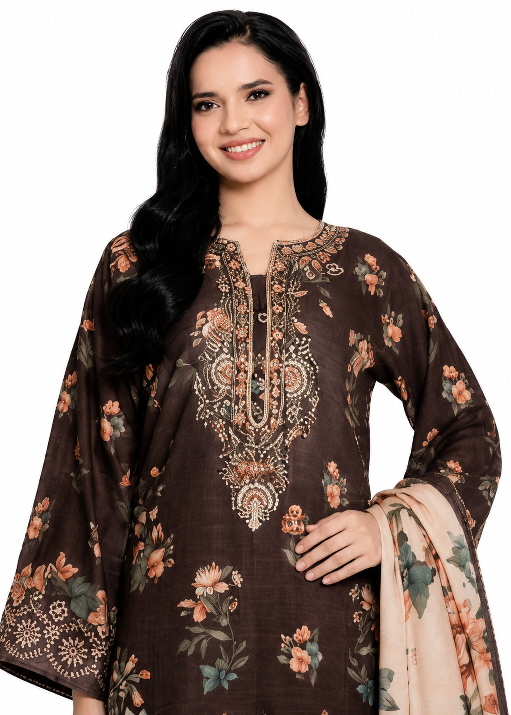 A woman modeling a dark brown three-piece salwar kameez suit set with beige and orange floral prints, featuring an embroidered kameez collar and a matching dupatta.