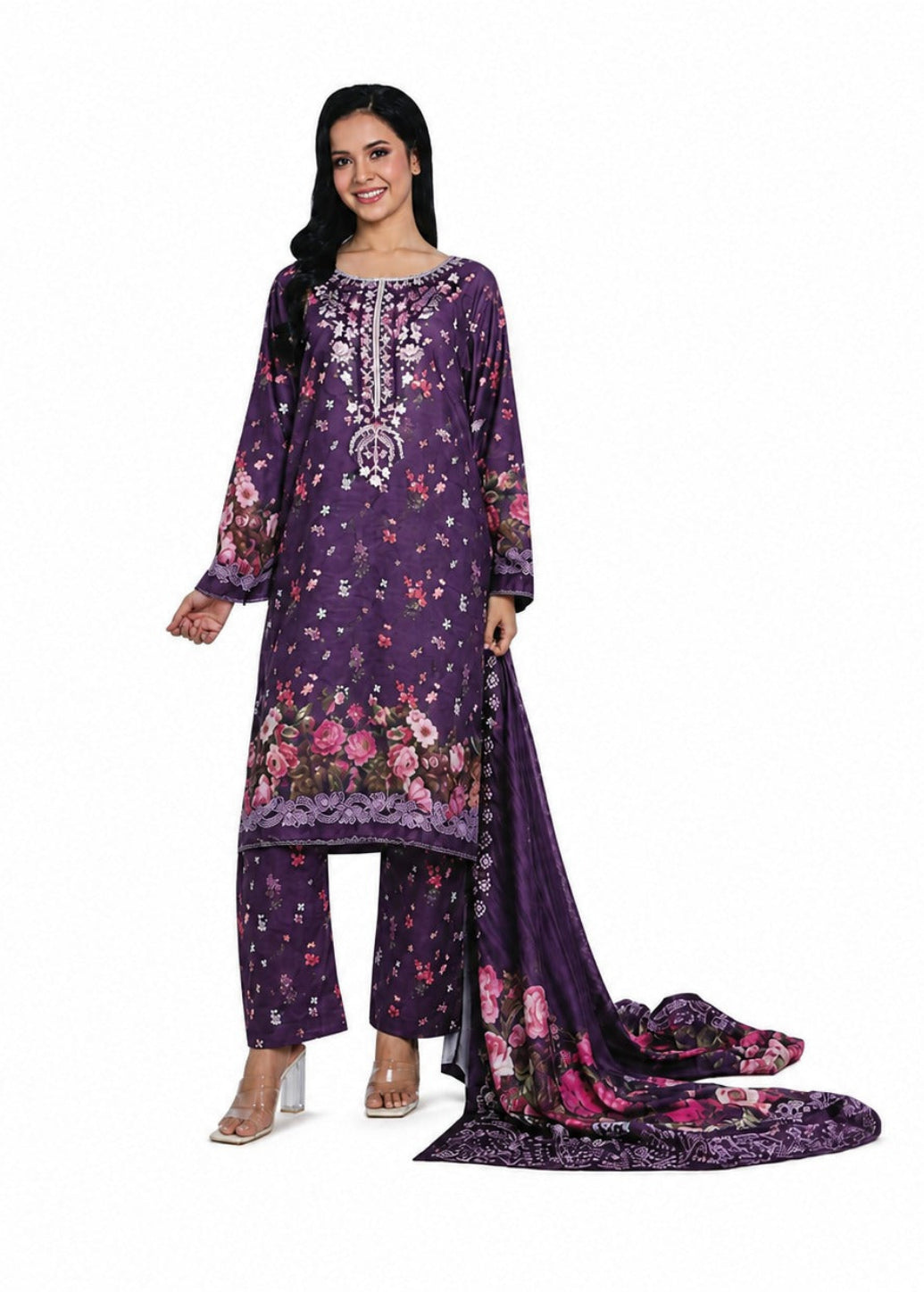 A woman models a three-piece traditional outfit consisting of a purple floral printed kurta, matching wide-leg pants, and a coordinating dupatta, set against a plain white background.