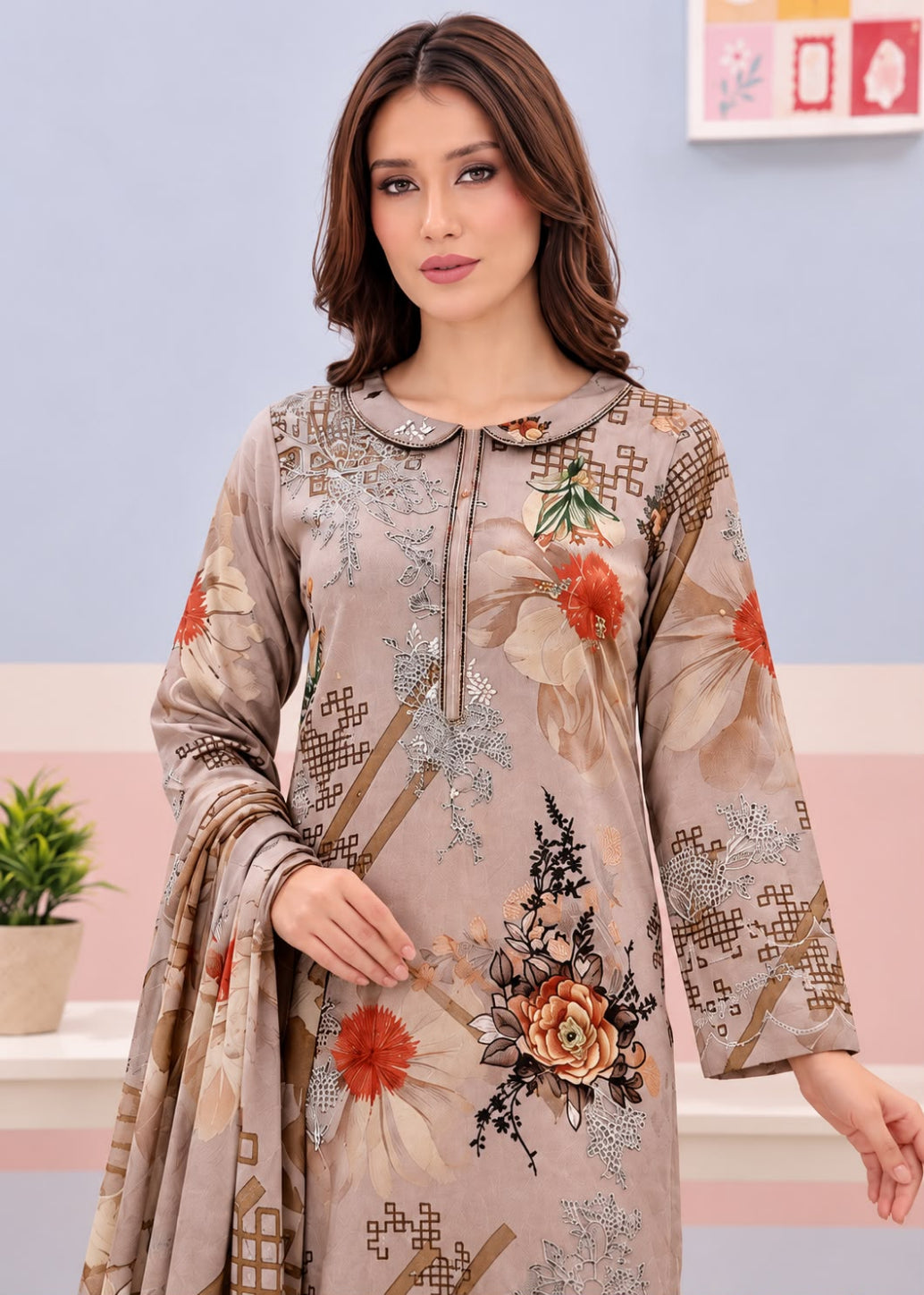A woman modeling a beige printed salwar kameez suit with floral and geometric patterns, featuring a drawstring collar and three-quarter sleeves.