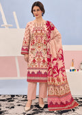 A woman modeling a traditional three-piece salwar kameez suit in light pink with intricate red and gold embroidery, paired with matching pink trousers and a large floral printed dupatta.