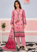 A woman models a pink three-piece ethnic suit set consisting of a long-sleeve kurta with floral embroidery, matching pink trousers, and a coordinating dupatta, set against a pastel pink and blue wall background.