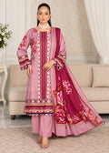 A woman models a traditional Indian salwar kameez suit in dusty pink and magenta with intricate floral embroidery and border prints, set against a neutral indoor living room background.
