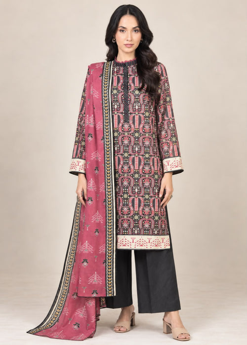 A woman modeling a traditional three-piece salwar kameez suit set. The set features a dusty pink printed kameez kurta with black and beige geometric patterns, black wide-leg trousers, and a matching pink printed dupatta with a black border.