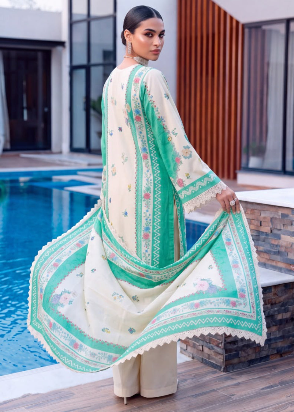 A woman modeling a traditional South Asian outfit in a split-screen lifestyle photo. The outfit consists of a cream-colored kurta with delicate floral prints and green border details, paired with matching wide-leg trousers and a coordinating green and cream dupatta.