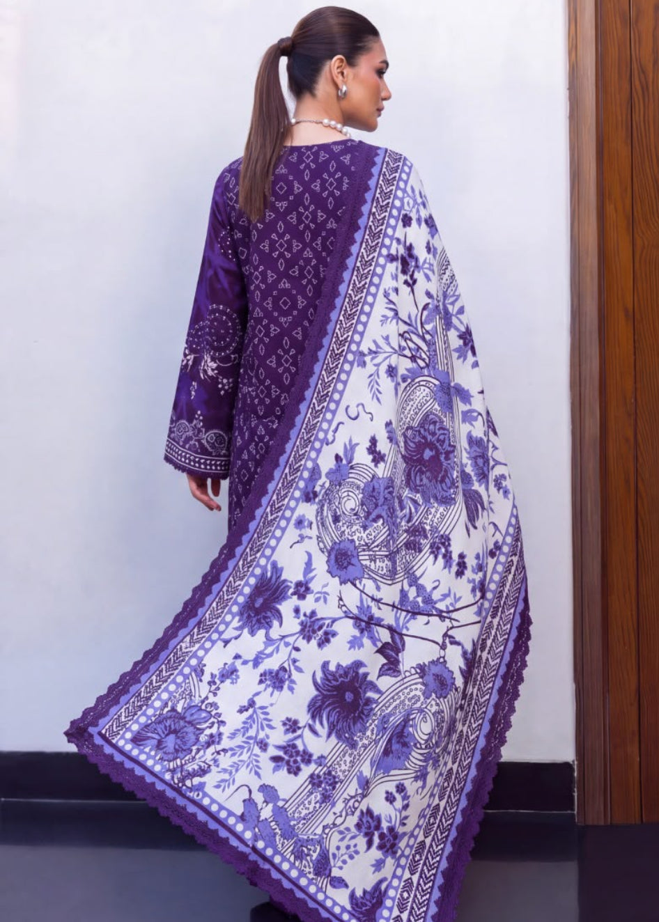A model is shown wearing a purple and white printed traditional outfit, featuring a long-sleeved purple kurta and a matching printed dupatta, shown in both front and back views.