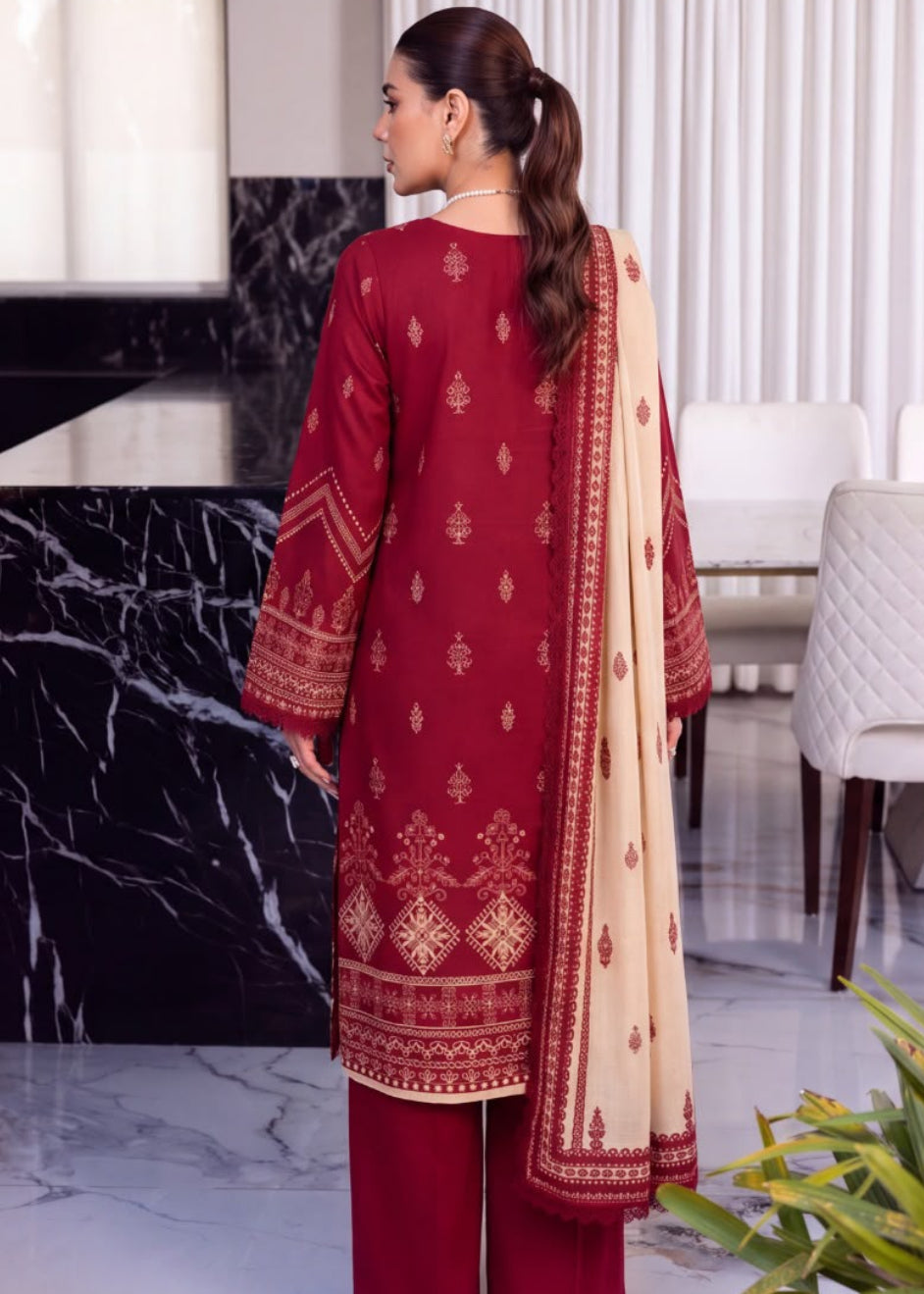 A woman modeling a traditional South Asian salwar kameez suit set in a split view. The left panel shows her from the back, wearing a deep maroon kurta with gold embroidery, matching maroon trousers, and a beige dupatta with a maroon border.
