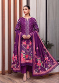 A woman models a traditional Indian salwar kameez suit in deep purple. The outfit features intricate white embroidery on the kameez tunic, a matching purple dupatta with pink and green floral prints and scalloped borders, and coordinating purple trousers.
