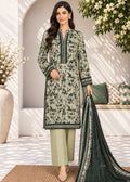 A woman models a three-piece Indian ethnic salwar kameez suit set. The set features a light sage green kurta with a black floral print and border embroidery, paired with matching sage green trousers and a dark green dupatta with a black geometric border.
