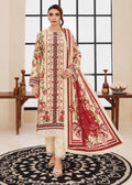 A woman models a traditional South Asian three-piece salwar kameez suit set. The set features a cream-colored long kurta with red and green floral embroidery, matching cream trousers, and a coordinating red dupatta with cream borders and floral prints.