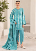 A woman modeling a teal blue and white printed salwar kameez suit with matching pants and a dupatta, standing in a modern indoor setting.