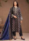 A woman models a traditional three-piece salwar kameez suit. The set includes a navy blue kurta with intricate gold and white floral patterns, black trousers with gold patterned hem borders, and a matching navy blue dupatta with gold and white borders.