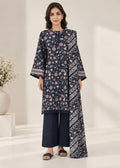 A woman models a navy blue three-piece kurta suit with floral and geometric prints, featuring a tunic top, wide-leg trousers, and a matching dupatta, set against a bright, minimalist indoor background.