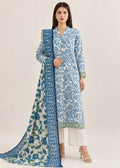 A woman modeling a traditional Indian salwar kameez suit set. The outfit features a light blue and white floral printed kurta with a green border, paired with white trousers and a matching blue and white printed dupatta with a blue border, set against a plain beige background.