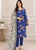 A woman models a three-piece Indian salwar kameez suit set. The set includes a royal blue long-sleeve kurta with a floral print, matching blue trousers, and a light blue dupatta with a detailed multicolor border and floral pattern.