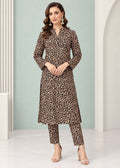 A woman modeling a brown and black leopard print kurta set with matching pants, standing in a studio with a light green and white background.
