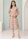 A woman models a long-sleeved, knee-length kurta with a dense multicolor floral and paisley print on a light beige base, paired with beige trousers and nude high-heeled sandals in a bright, modern studio setting.