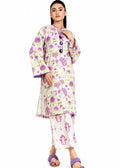 A woman modeling a traditional Indian outfit consisting of a cream-colored kurta and pant set with a vibrant pink, purple, and green floral print. The kurta features a mandarin collar and a decorative black and purple embroidered placket.