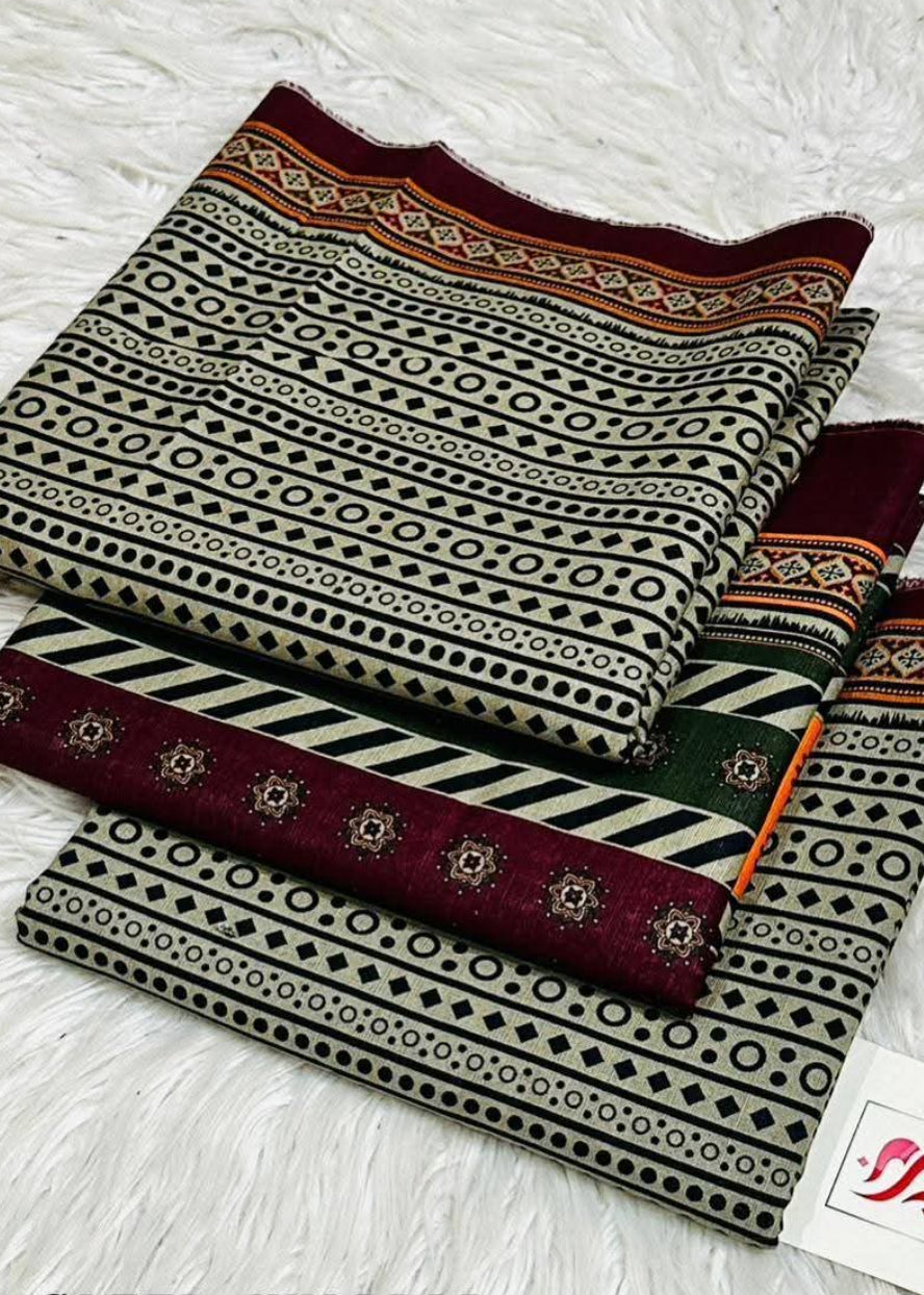 Three folded pieces of patterned fabric arranged on a white faux-fur surface. The fabrics feature black, beige, and burgundy geometric and striped patterns, with one piece showing a small green accent stripe.