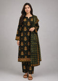 A woman modeling a black and green plaid kurta set with gold floral embroidery and a matching dupatta, photographed against a neutral gray studio background.