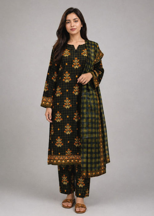 A woman modeling a black and green plaid kurta set with gold floral embroidery and a matching dupatta, photographed against a neutral gray studio background.